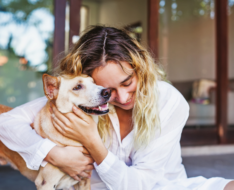 woman caressing pet dog