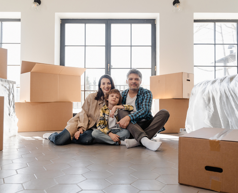 parents and kids with boxes in house