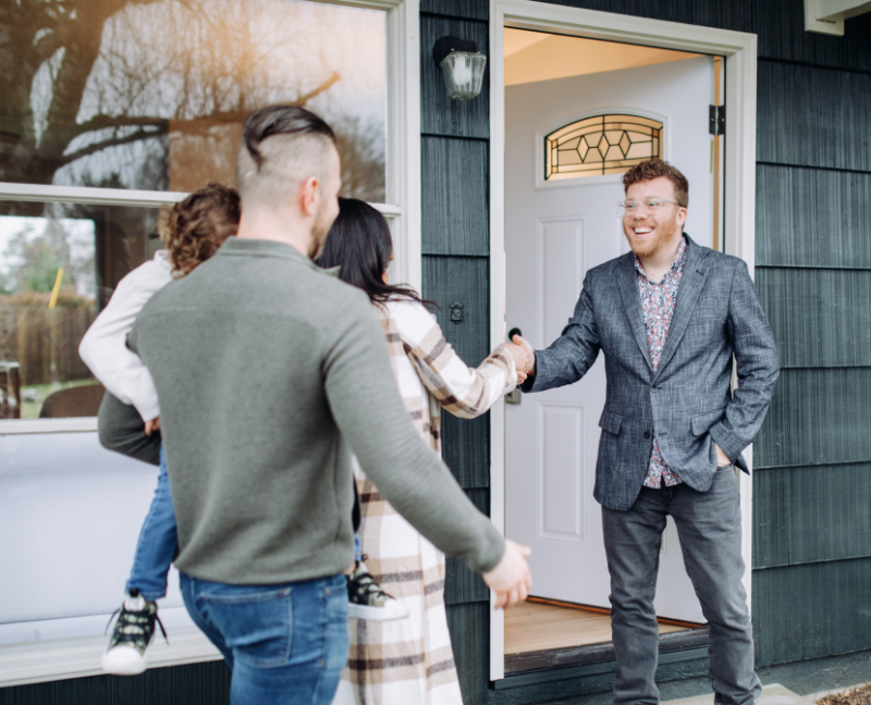 real estate smiling shaking hands with clients