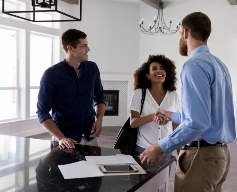 young couple greeting realtor