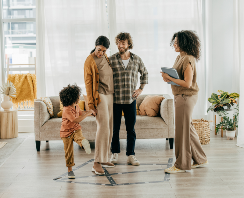 parents with child in new house with real estate agent