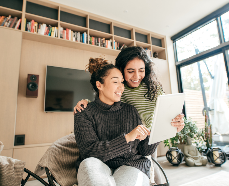 two millennials holding paper