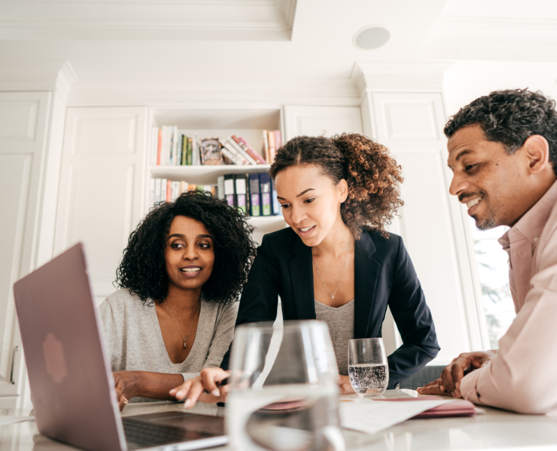 home buyers talking to real estate agent