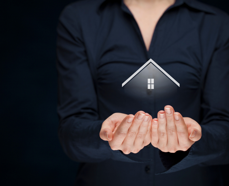 woman holding house figure