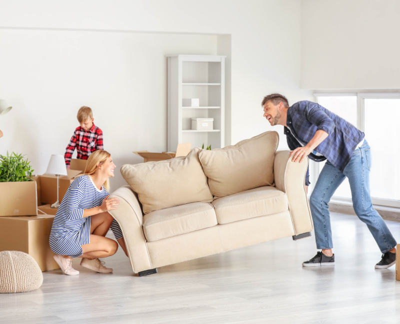 couple moving furniture in their new home