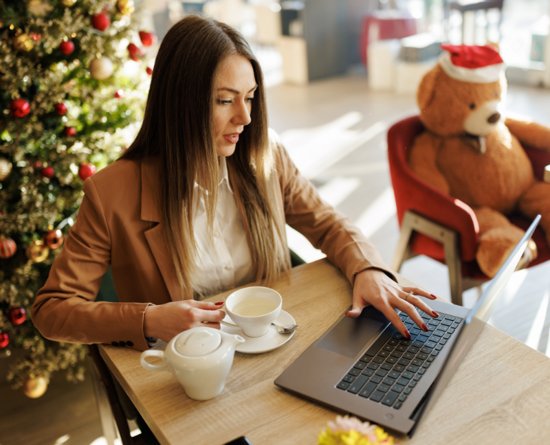 real estate agent using laptop with christmas tree background