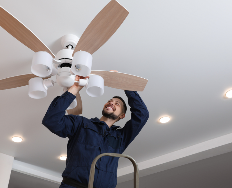man repairing the ceiling fan