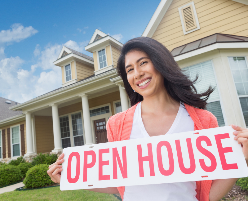 agent holding an open house sign