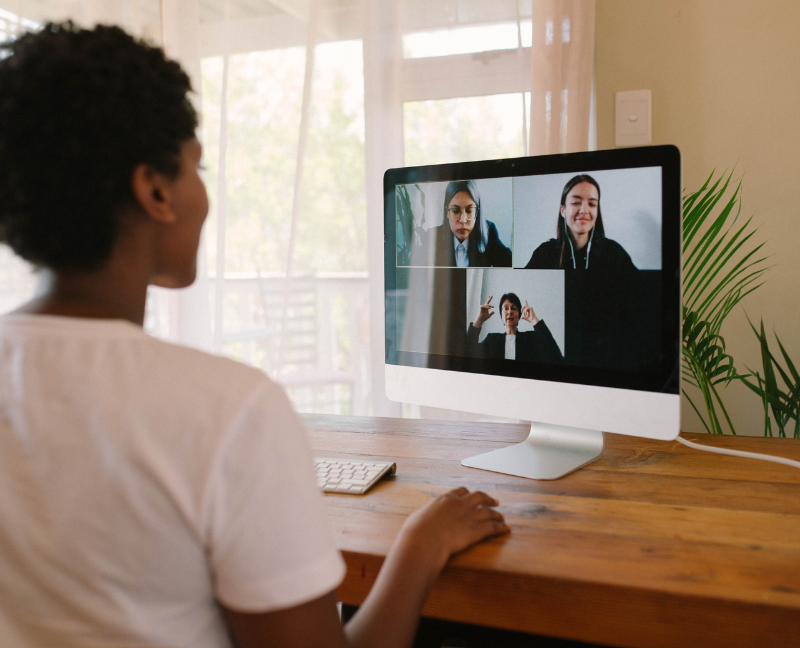 woman video chatting with remote workmates