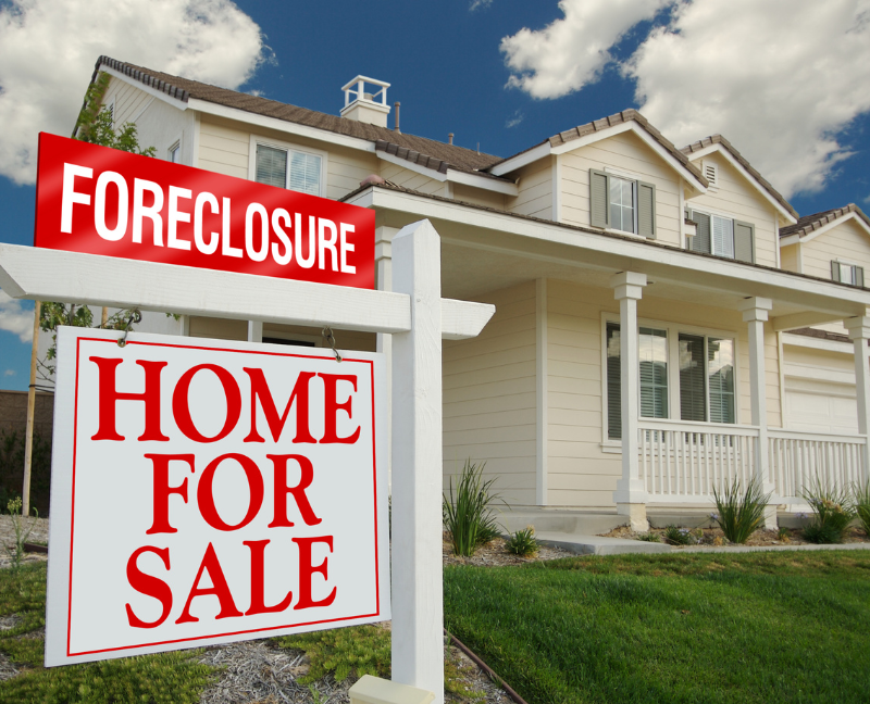 house with home for sale foreclosure sign