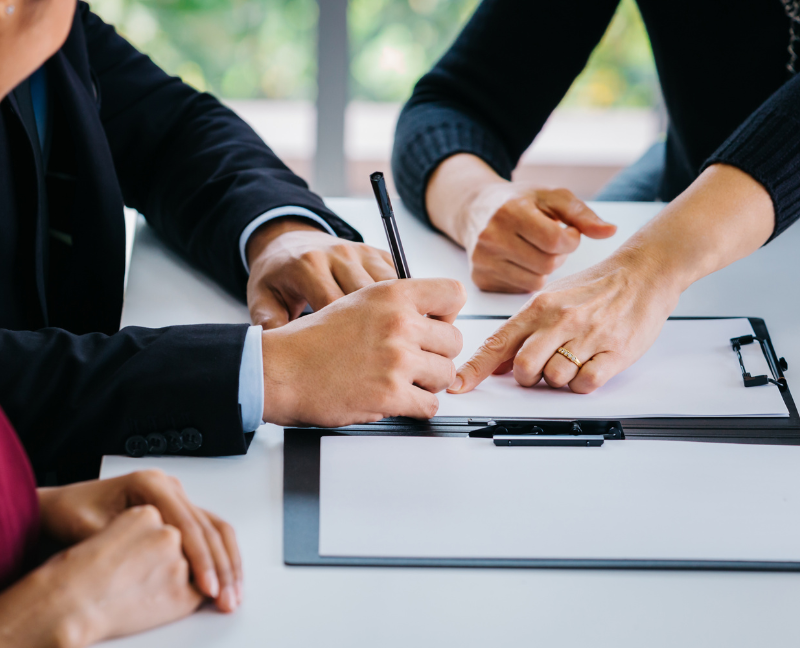 divorcing couple signing an agreement