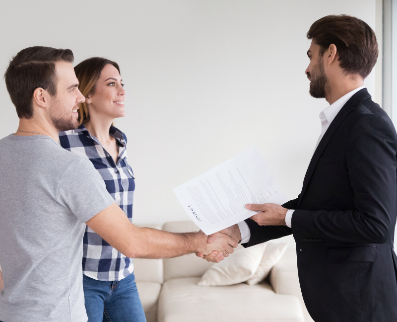 clients shaking hands with realtor