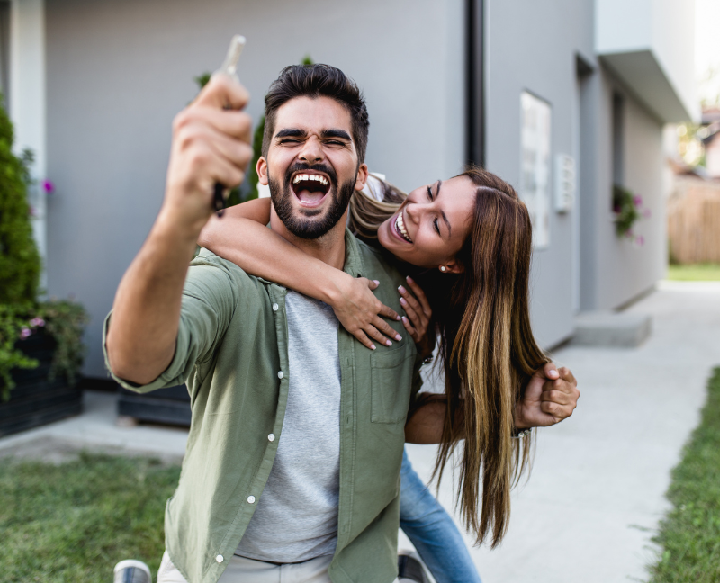 happy couple holding house keys