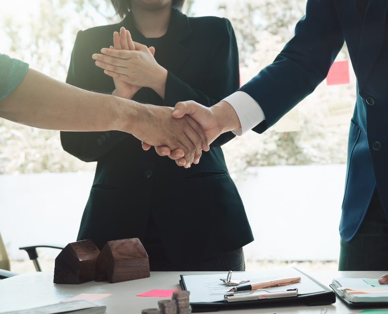 real estate agent and client shaking hands