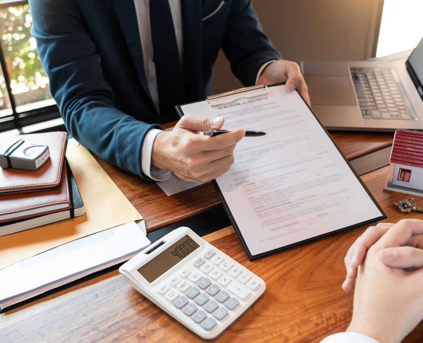 agent showing a document to a potential buyer